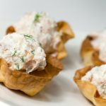 4 smoked salmon and dill cups on white plate.