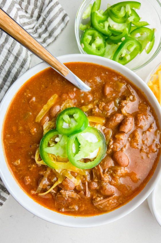 Overhead bowl of instant pot chili with a spoon.