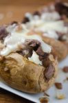 Make baked potatoes a meal with these French-Style Beef Baked Potatoes. They are loaded with thinly slice top sirloin, caramelized onion sauce and shredded Swiss cheese.