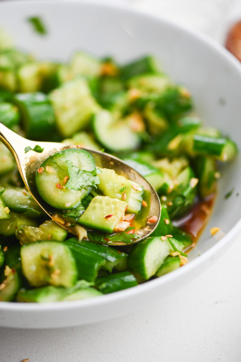 Spoonful of smashed cucumber salad. 