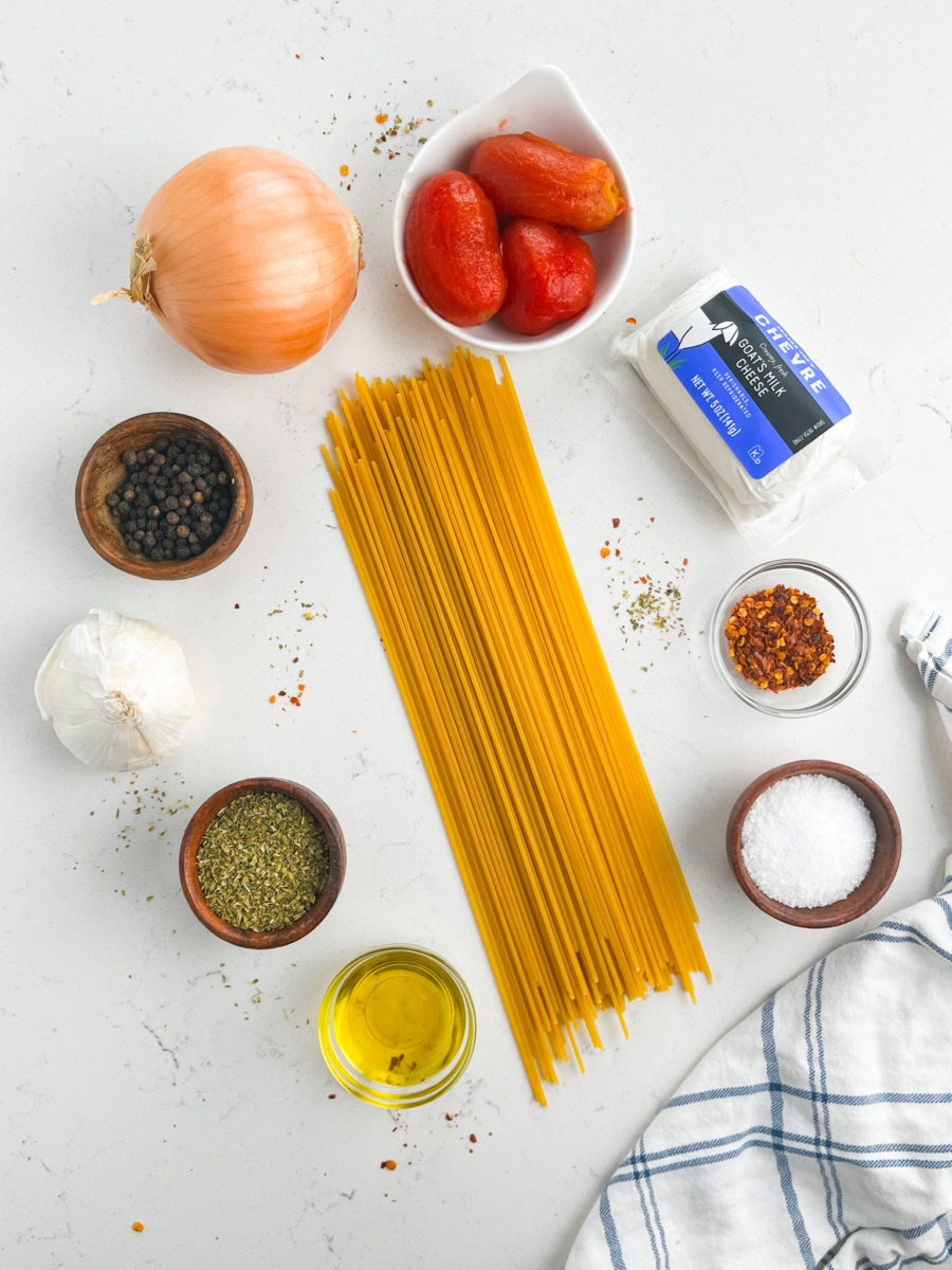 Creamy marinara sauce ingredients on white background. 