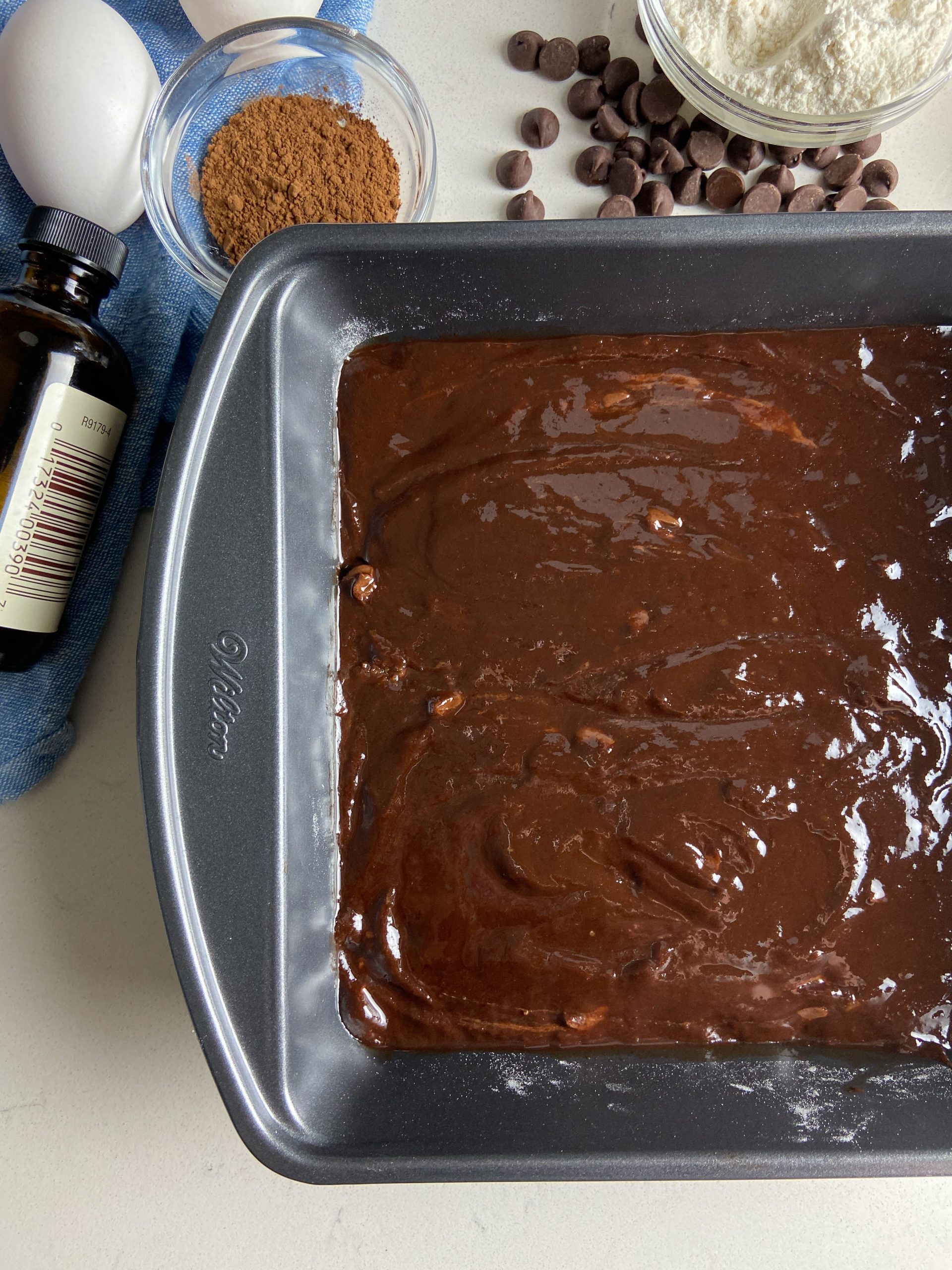 Raw brownie batter in a baking dish. 