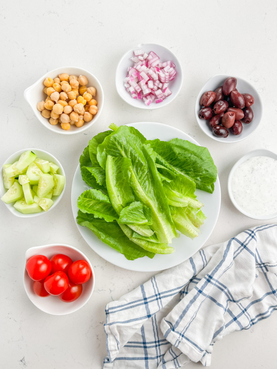 Greek Chopped Salad ingredients on white background. 