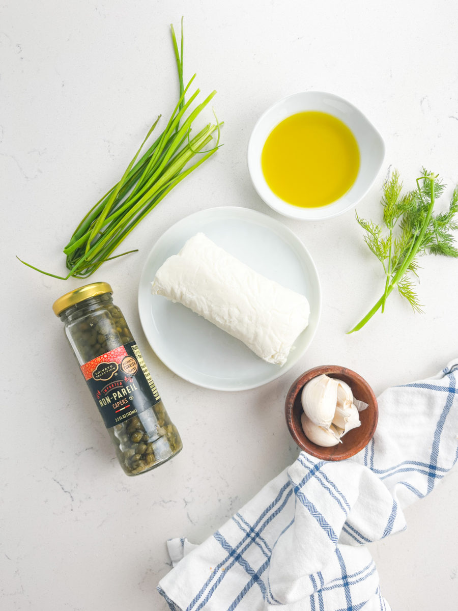 Herb Marinated Goat Cheese ingredients on a white background. 