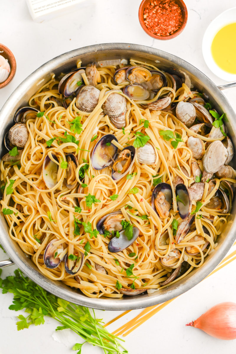 Linguine with clams in large stainless steel pan. 