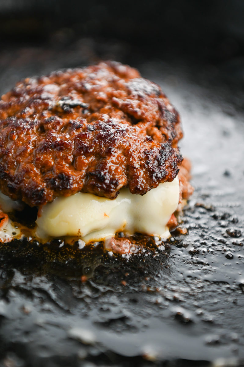 Smash burgers in a cast iron skillet. 